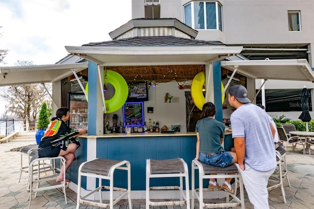 view of patio with an outdoor bar