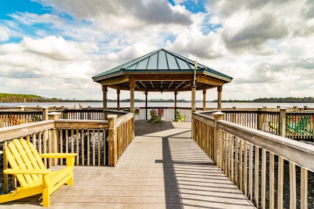 dock area featuring a deck with water view and a gazebo