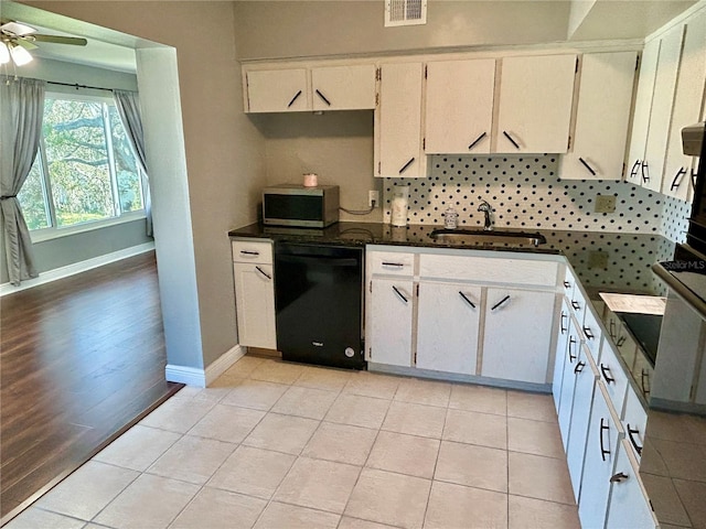 kitchen featuring dishwasher, white cabinetry, and light hardwood / wood-style flooring