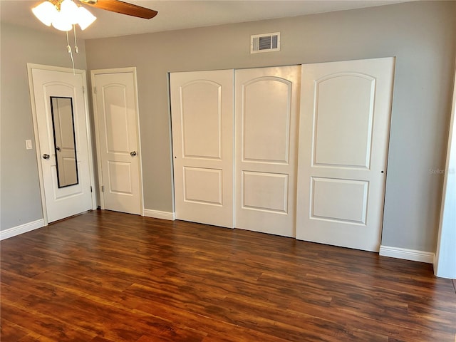 unfurnished bedroom with dark hardwood / wood-style floors and ceiling fan