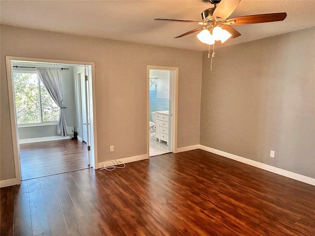 empty room featuring ceiling fan and dark hardwood / wood-style flooring