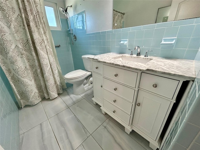 bathroom with toilet, a shower with shower curtain, vanity, and tile walls