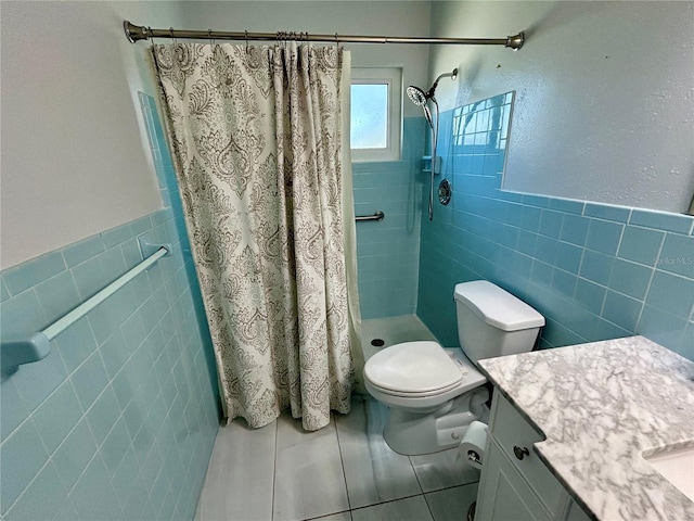 bathroom with vanity, toilet, tile walls, and curtained shower