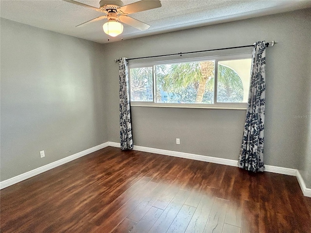 spare room with ceiling fan, a textured ceiling, and dark hardwood / wood-style floors