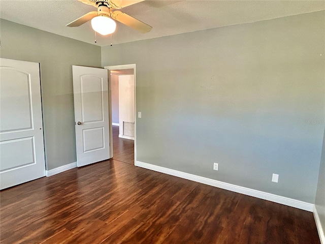 unfurnished bedroom with dark wood-type flooring and ceiling fan