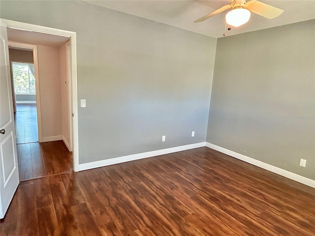 spare room featuring ceiling fan and dark hardwood / wood-style floors