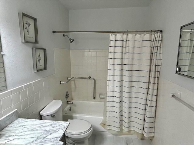 full bathroom with toilet, shower / bath combo, vanity, and tile walls