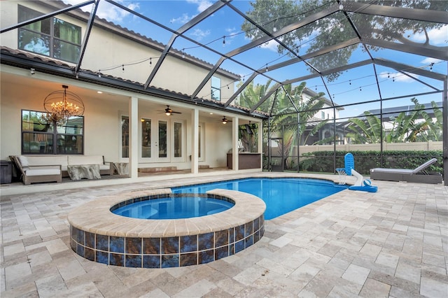 view of pool featuring a lanai, an in ground hot tub, ceiling fan, an outdoor hangout area, and a patio