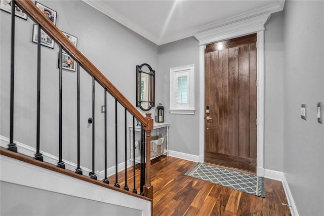 entrance foyer with dark wood-type flooring and ornamental molding