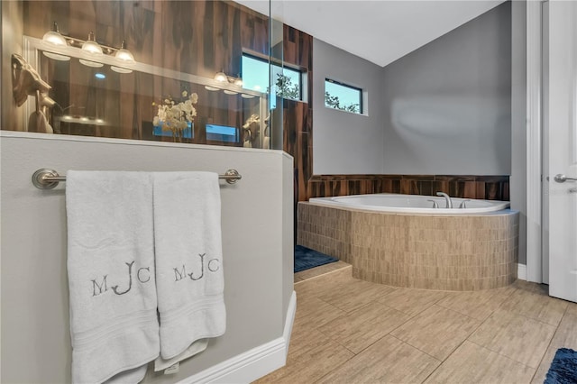 bathroom featuring a relaxing tiled tub