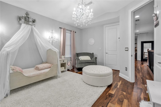 sitting room featuring vaulted ceiling, dark wood-type flooring, and a notable chandelier