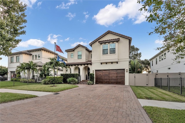 mediterranean / spanish-style home with a garage and a front lawn