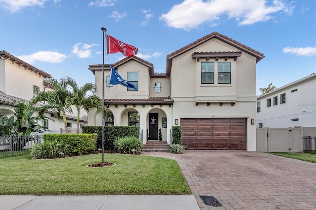 mediterranean / spanish home with a garage and a front yard