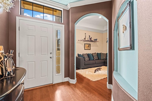 entryway featuring crown molding and wood-type flooring