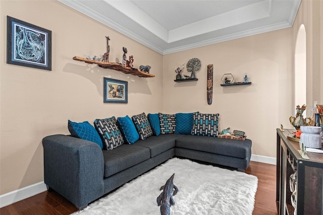 living room with a tray ceiling, ornamental molding, and dark hardwood / wood-style flooring