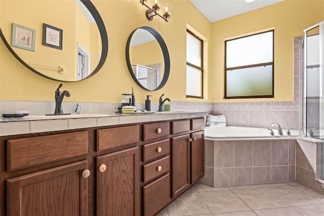 bathroom featuring vanity, a healthy amount of sunlight, tile patterned flooring, and plus walk in shower