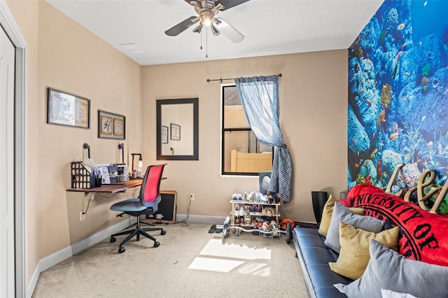 carpeted home office with ceiling fan