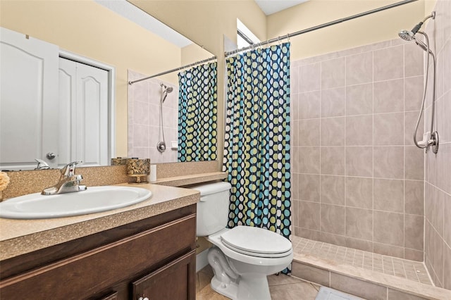 bathroom with vanity, tile patterned flooring, toilet, and walk in shower