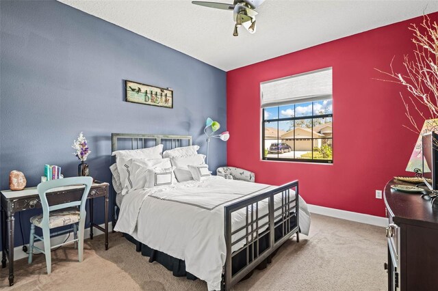 bedroom with light carpet and ceiling fan