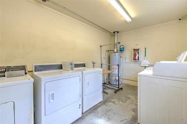 laundry area with gas water heater and separate washer and dryer