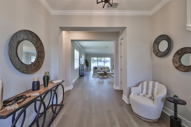 hallway featuring ornamental molding and wood-type flooring