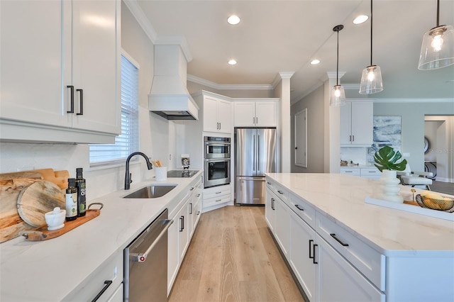 kitchen featuring white cabinets, decorative light fixtures, custom exhaust hood, appliances with stainless steel finishes, and light stone counters