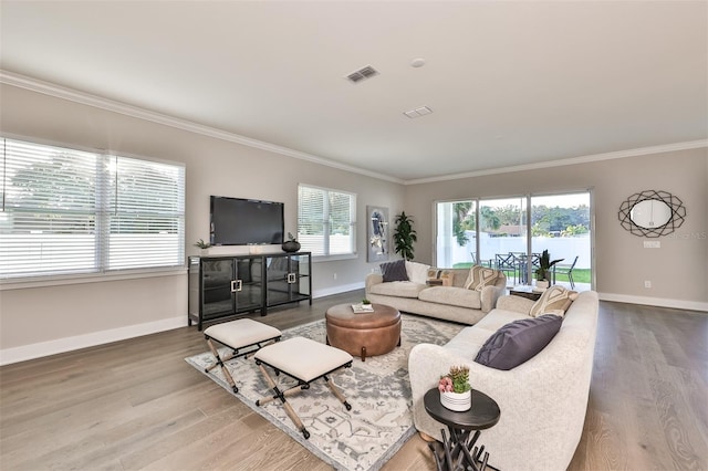 living room with crown molding and hardwood / wood-style floors