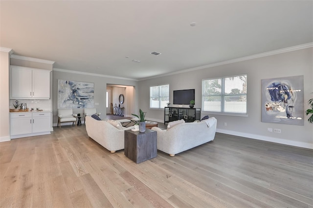 living room with crown molding and light hardwood / wood-style flooring