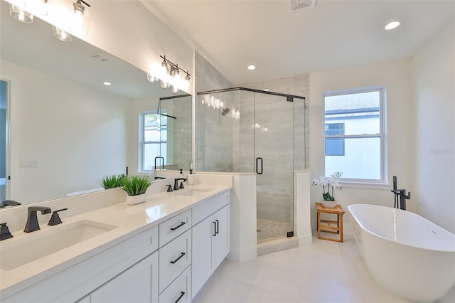 bathroom featuring vanity, tile patterned floors, and shower with separate bathtub