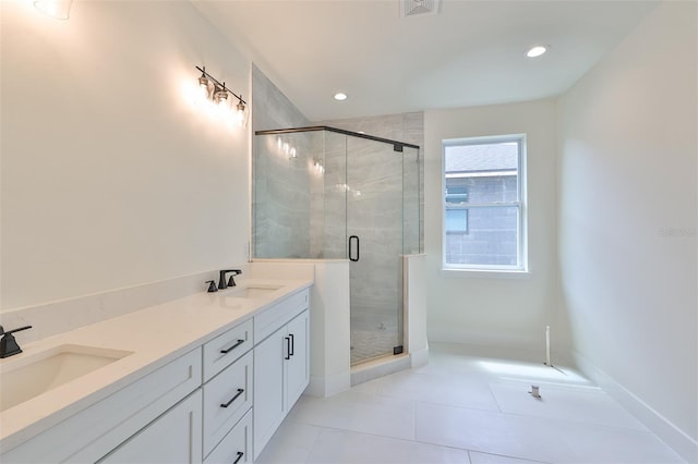 bathroom featuring vanity, an enclosed shower, and tile patterned floors