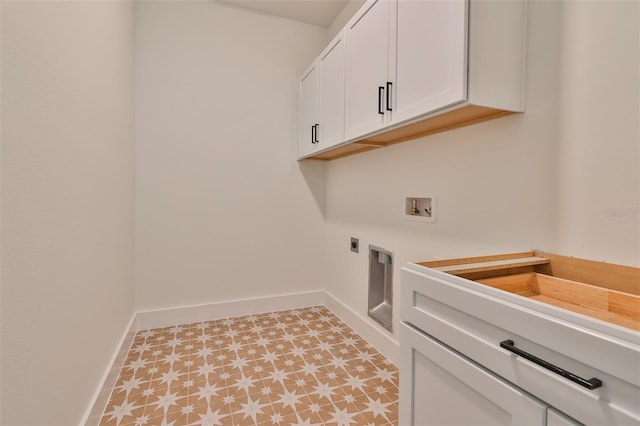 clothes washing area featuring cabinets, hookup for an electric dryer, and washer hookup