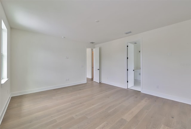 spare room featuring light wood-type flooring