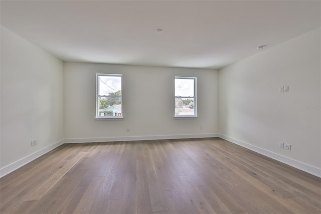 empty room featuring a wealth of natural light and light hardwood / wood-style floors