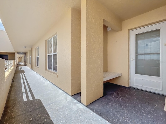 entrance to property featuring stucco siding