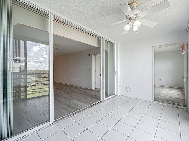 interior space with a balcony and ceiling fan