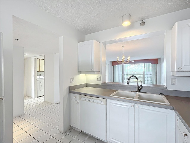 kitchen with dishwasher, a notable chandelier, white cabinets, washer / clothes dryer, and a sink