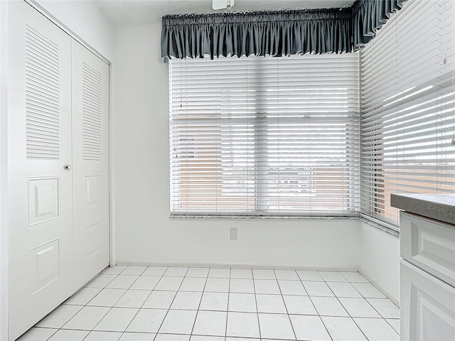 unfurnished dining area featuring light tile patterned floors