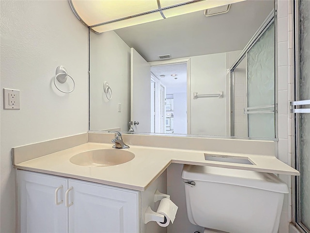 bathroom featuring vanity, toilet, and visible vents