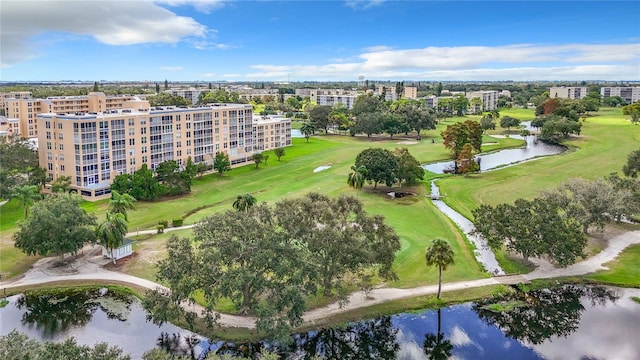 birds eye view of property with view of golf course and a water view