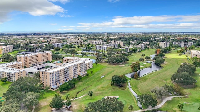 aerial view with view of golf course, a view of city, and a water view