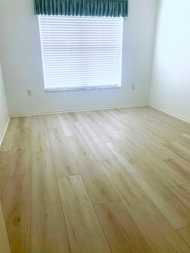 empty room with wood finished floors