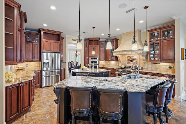 kitchen featuring a spacious island, stainless steel appliances, backsplash, pendant lighting, and premium range hood