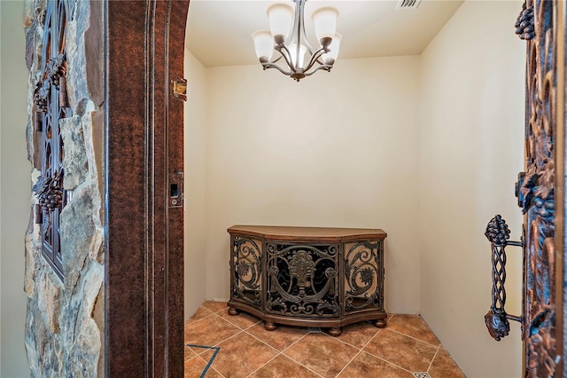 interior space featuring an inviting chandelier and tile patterned flooring