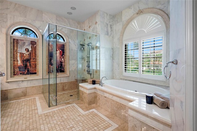 bathroom featuring shower with separate bathtub