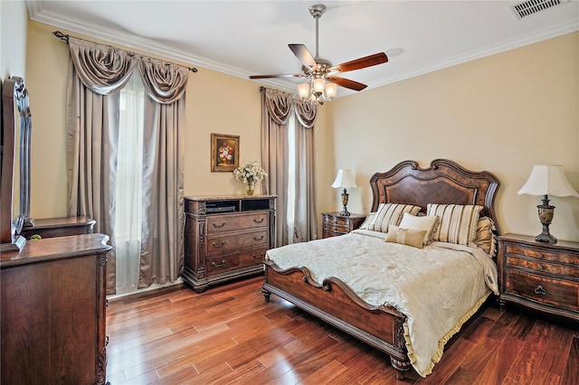 bedroom with crown molding, multiple windows, hardwood / wood-style flooring, and ceiling fan