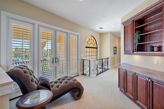 living area featuring light colored carpet