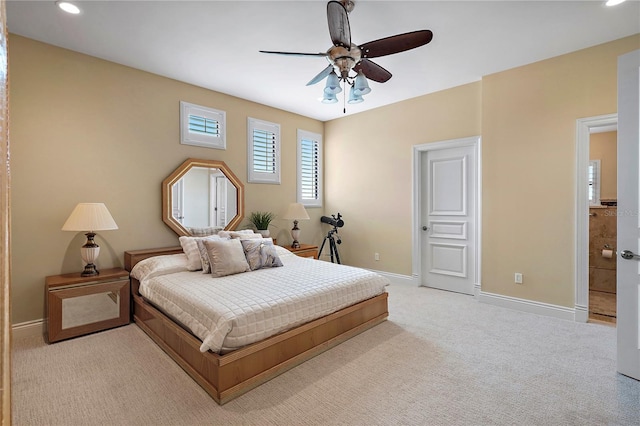 carpeted bedroom featuring connected bathroom and ceiling fan