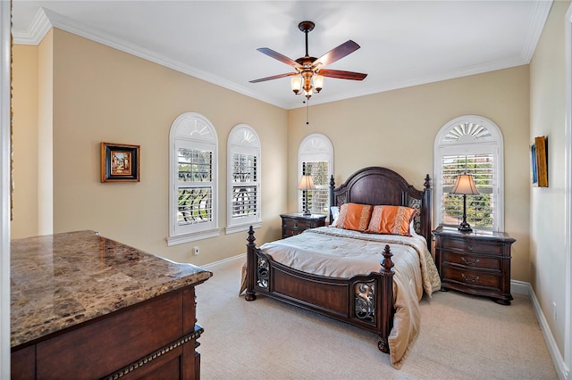 bedroom featuring ceiling fan, crown molding, and light colored carpet