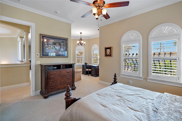 carpeted bedroom with crown molding, ceiling fan with notable chandelier, and decorative columns