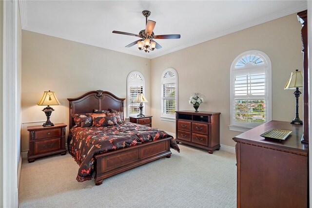 bedroom with ornamental molding, light colored carpet, and ceiling fan